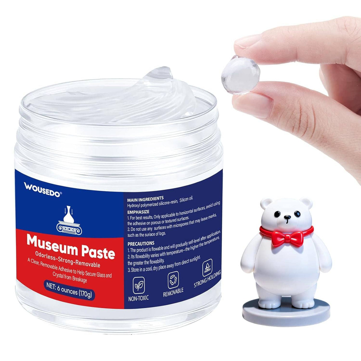 Jar of clear gel mounting paste, gel piece pinched above small figurine
