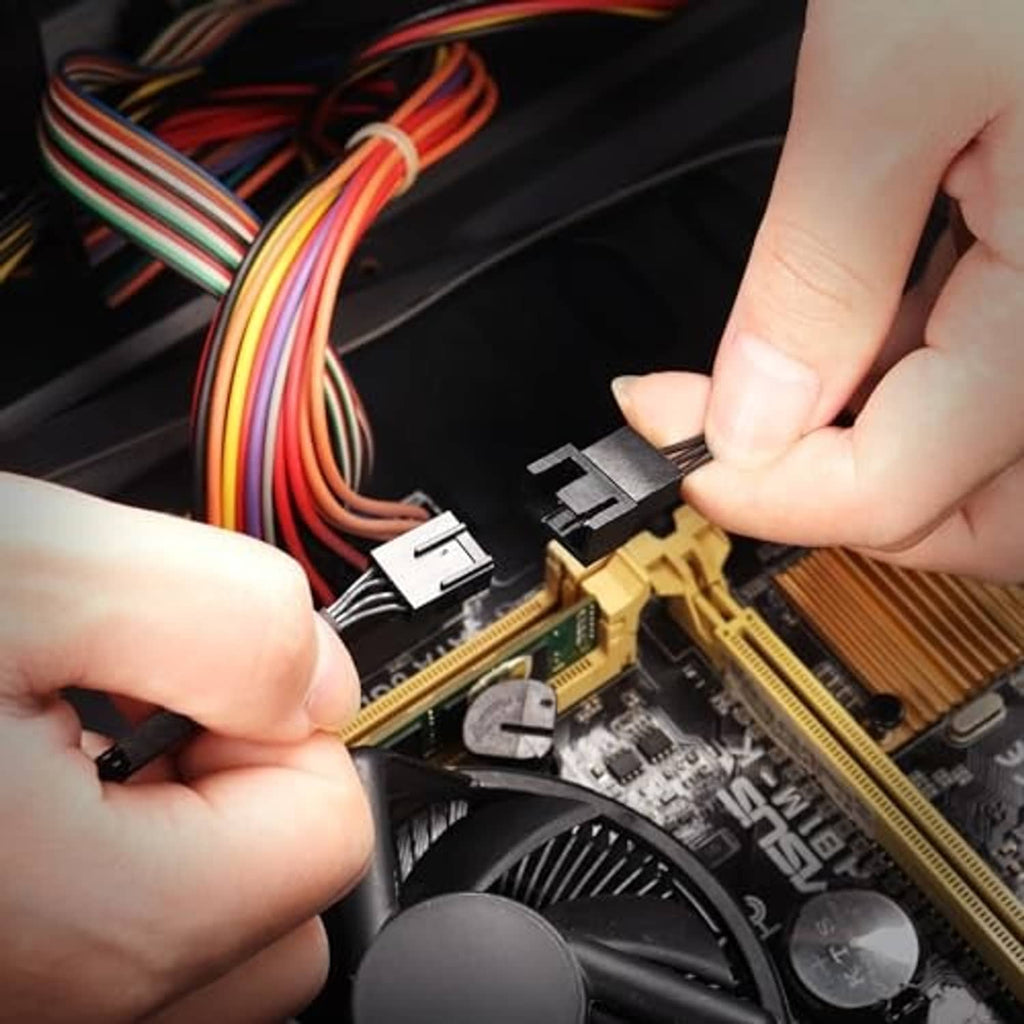 Hands plugging a fan adapter connector into a PC motherboard header