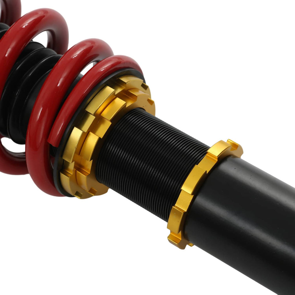 Coilover shock with red coil spring, gold adjuster rings, and black threaded body