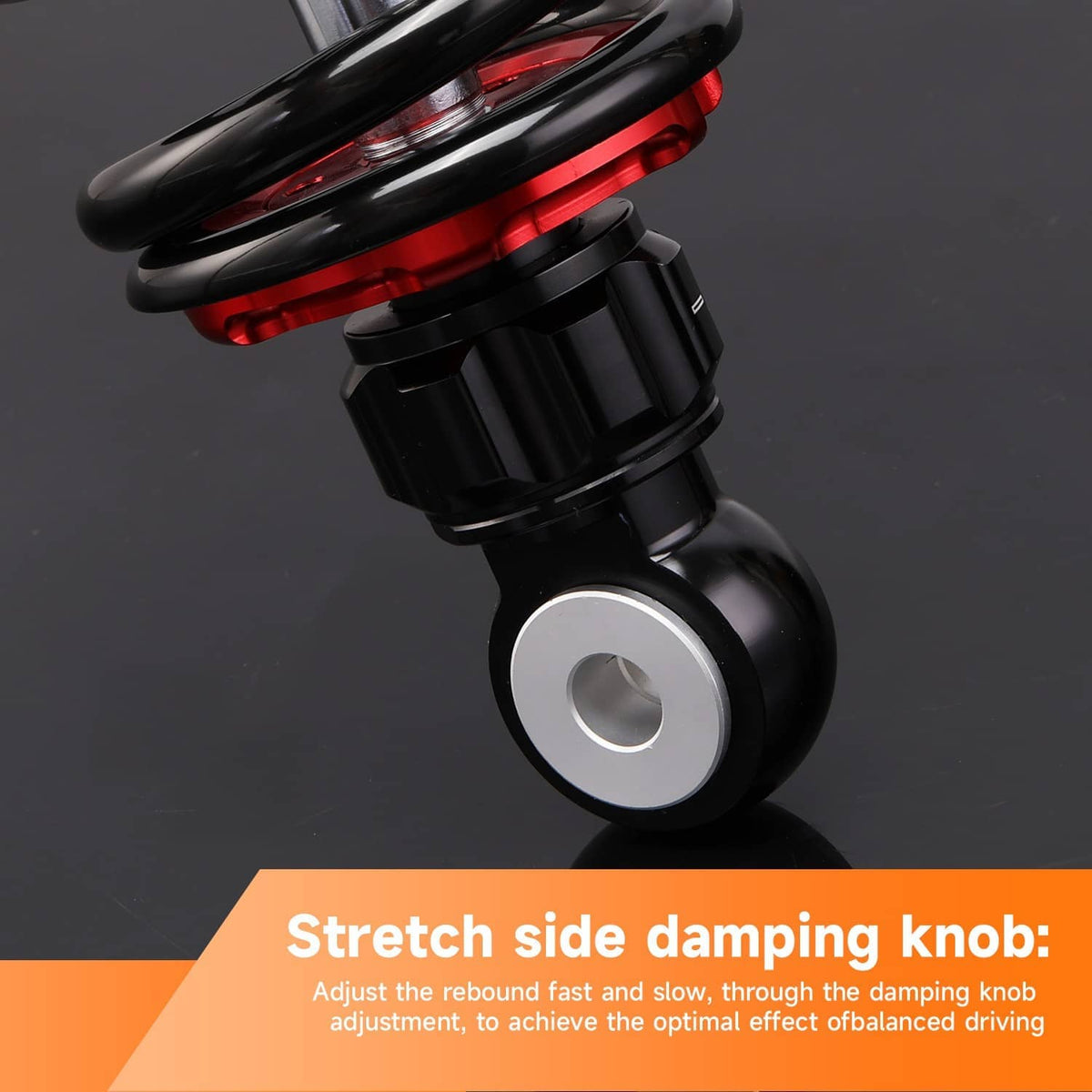 Rear shock absorber lower eye mount with black body and red coil spring