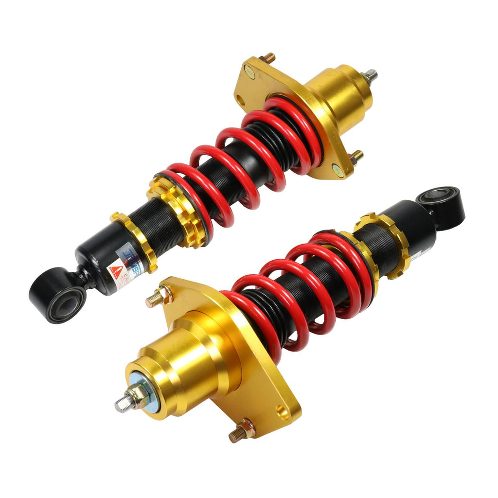 Two coilover shock struts with red springs, black dampers, and gold spring seats
