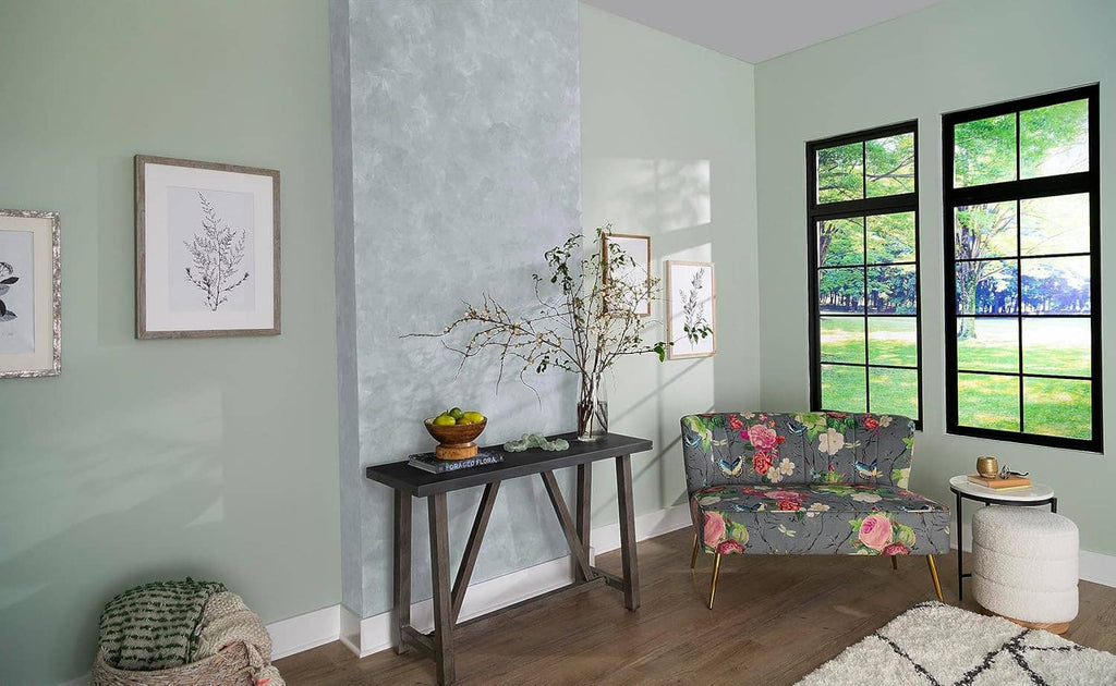Room with gray concrete-textured accent wall and window light