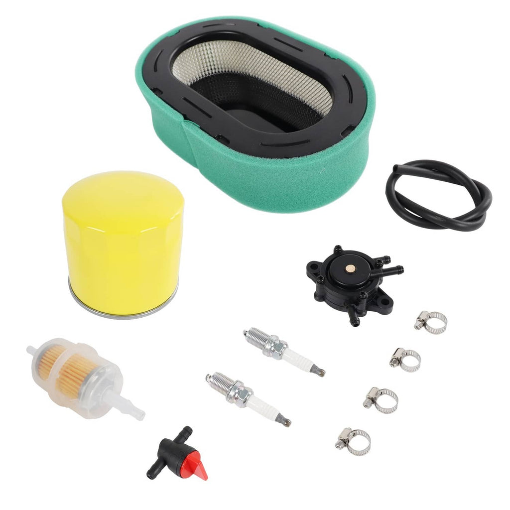 Air filter tune-up kit parts laid out: green air filter, yellow oil filter, fuel pump, plugs, clamps