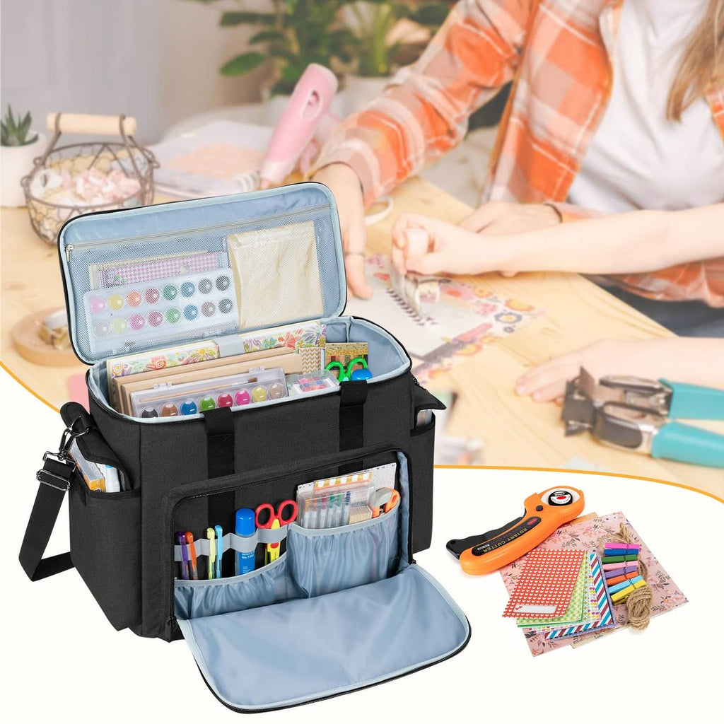 Open black scrapbook bag filled with craft supplies and an attached fabric divider