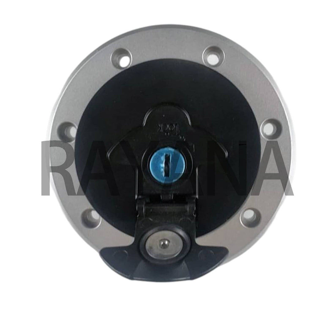 Fuel tank gas cap with blue lock cylinder detail and black cap insert, close-up.