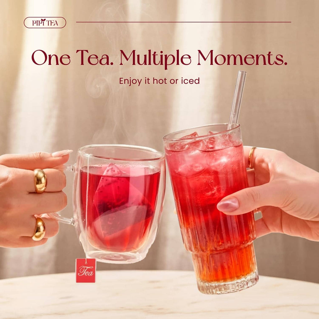 Iced hibiscus tea in clear glasses with ice and a pitcher, ruby-red drink