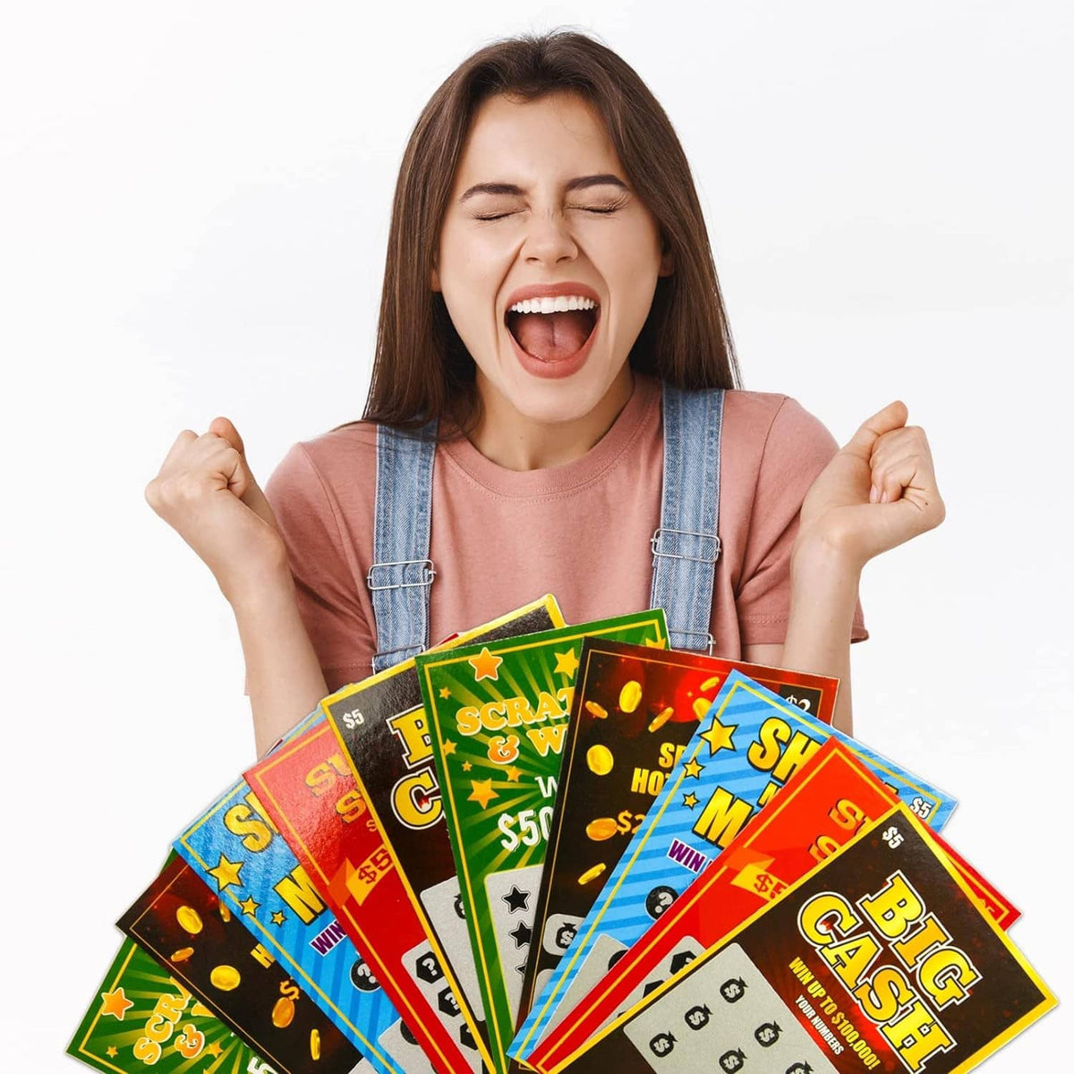 Happy woman holding multiple colorful scratch-off lottery tickets against a plain background