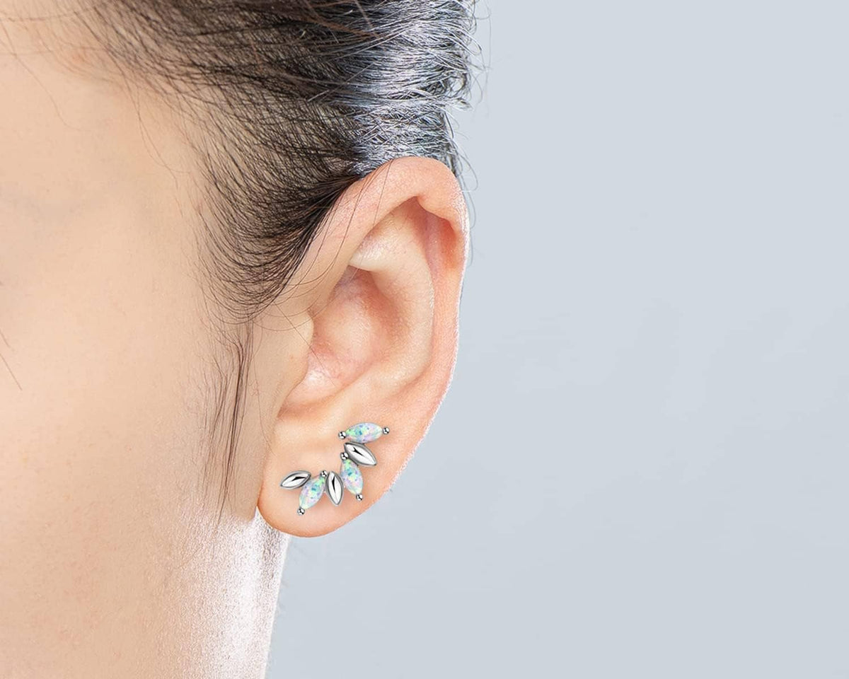 Sterling silver opal stud earrings on ear, marquise opal stones with ball backing