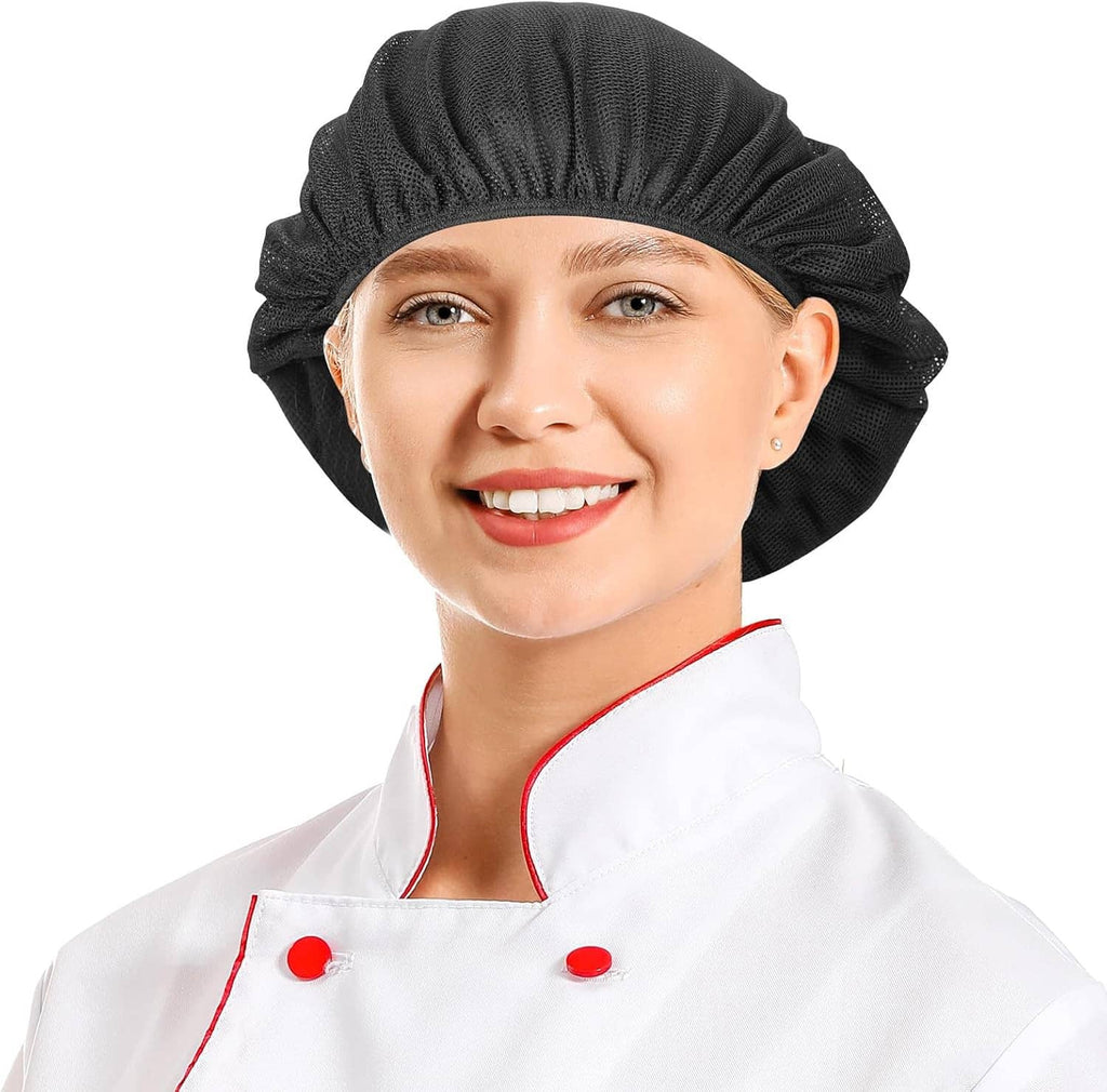 Black textured chef hairnet cap on smiling chef, white coat with red piping