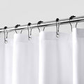 White shower curtain liner with metal rings and grommet holes for hanging