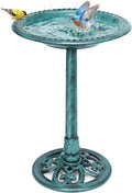Outdoor turquoise bird bath with pedestal stand and textured basin, birds splashing water