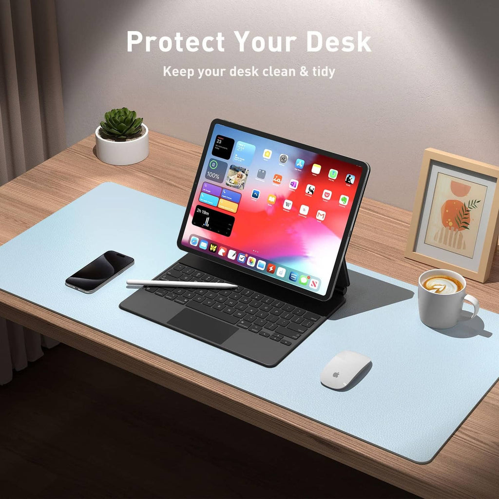 Baby blue leather desk pad protector on desk with laptop screen and computer mouse