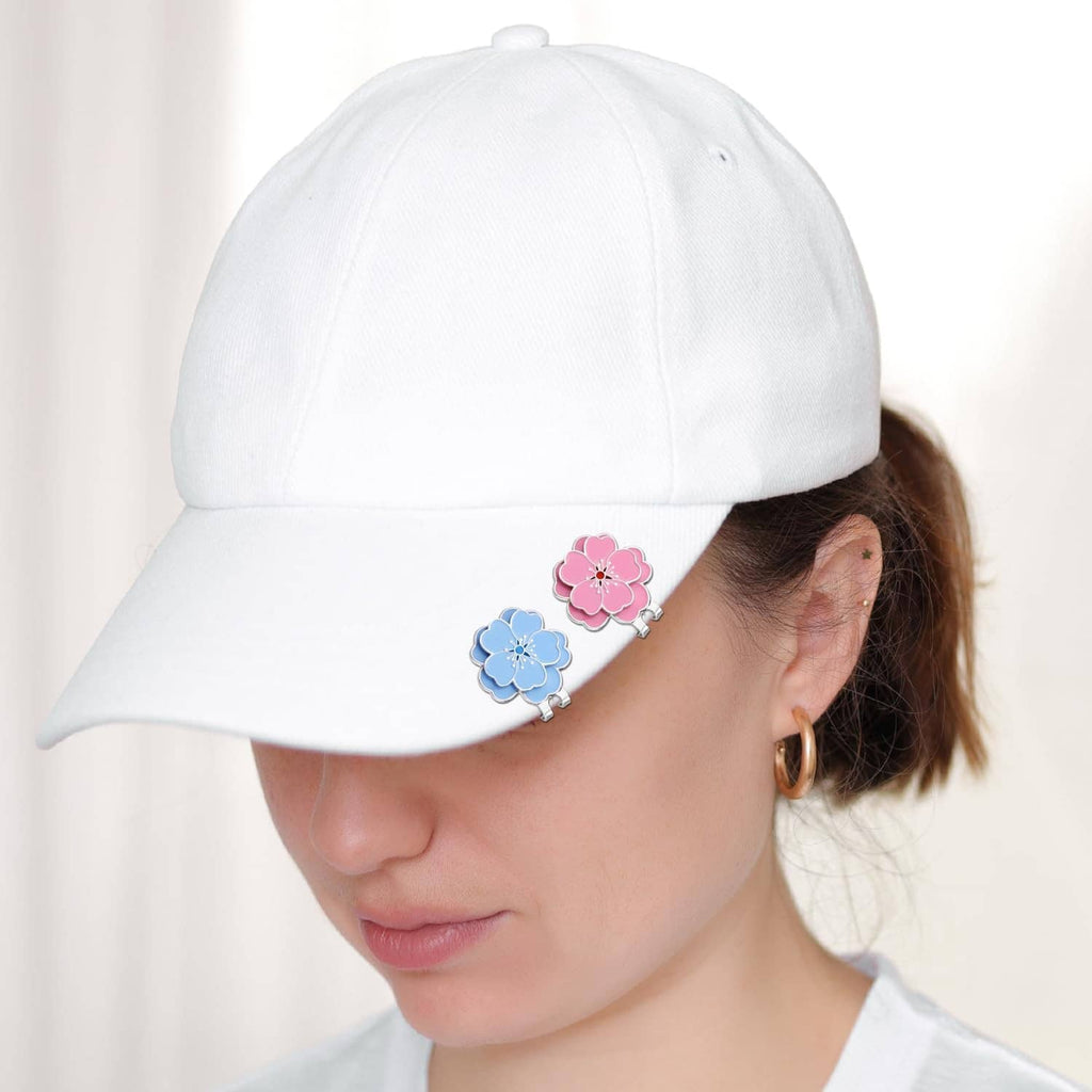 White baseball cap with blue and pink flower magnetic hat clip