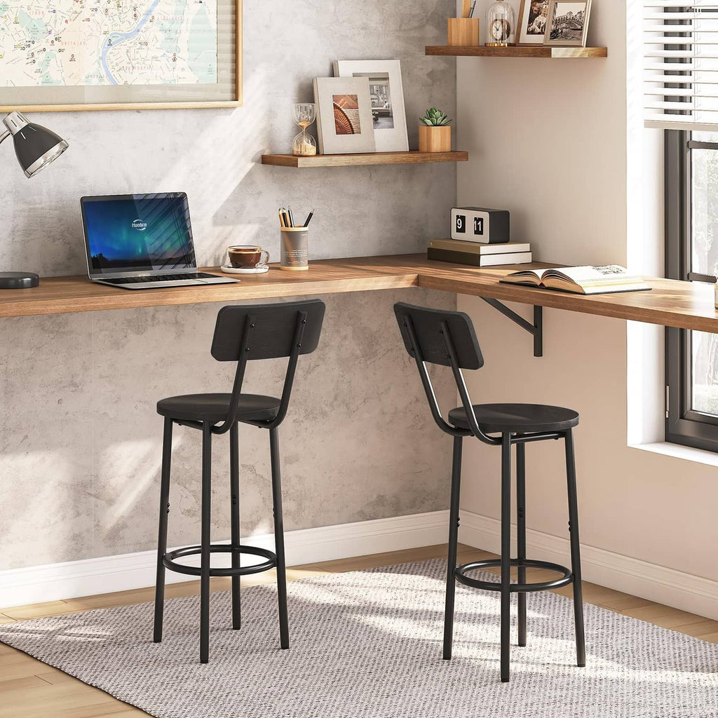 Two black bar stools with curved backrests, round seats, and circular footrests for counters