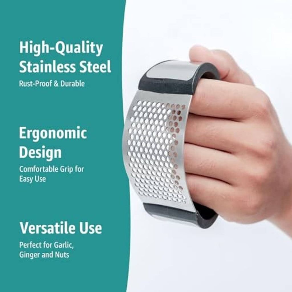 Black and stainless steel garlic press rocker with perforated crushing plate, held by hand