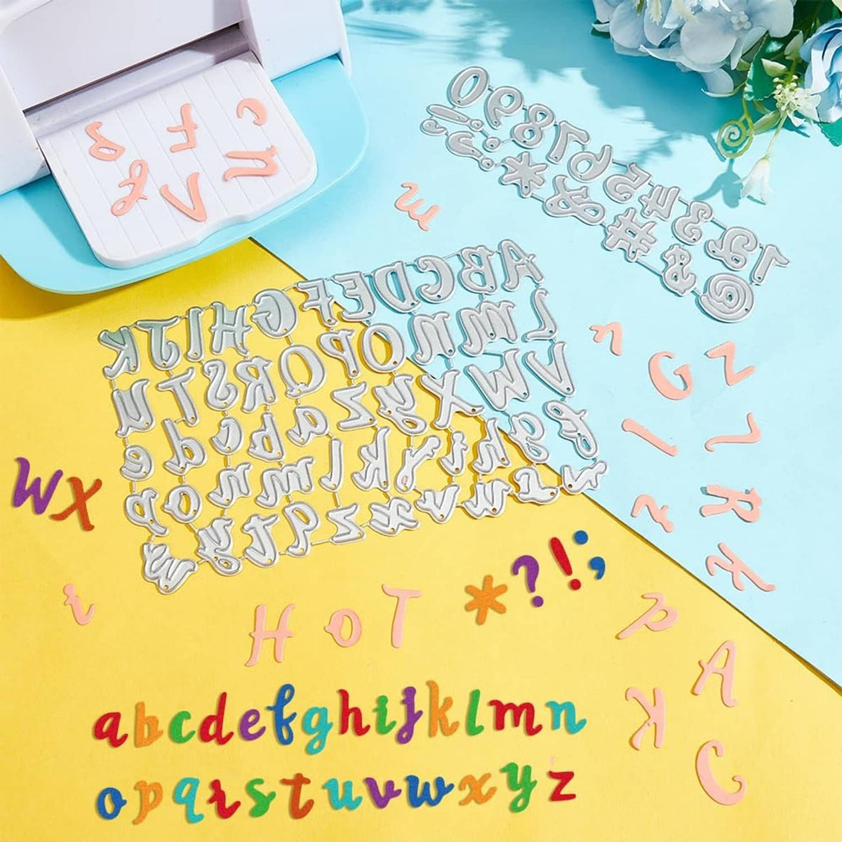 Alphabet and number cutting dies scattered on surface, mixed uppercase and lowercase
