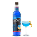DaVinci Gourmet Blue Curacao syrup bottle with blue cocktail in a stem glass