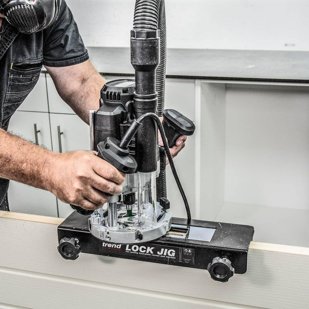 trend LOCK JIG mounted on a door panel with drill bit aligned for mortising