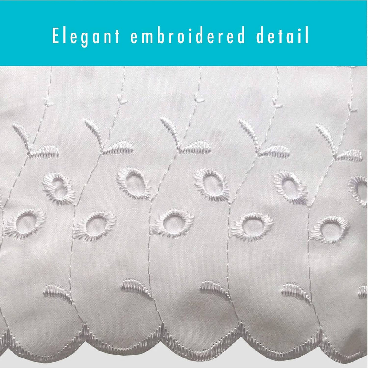 White eyelet embroidery close-up with scalloped cutwork and stitched medallion shapes