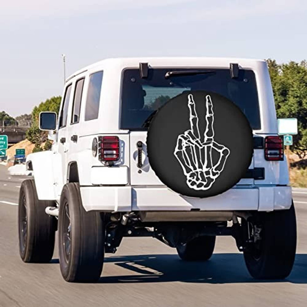 Black spare tire cover on vehicle rear with centered white peace-hand graphic