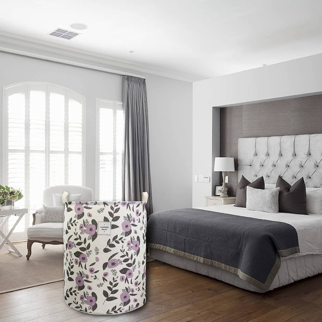 Collapsible laundry basket with purple floral print, standing upright with open top.