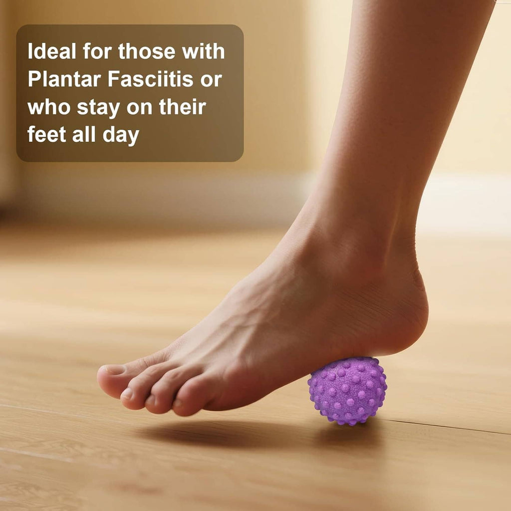 Foot massage ball with deep nubs in purple placed under the foot on the floor