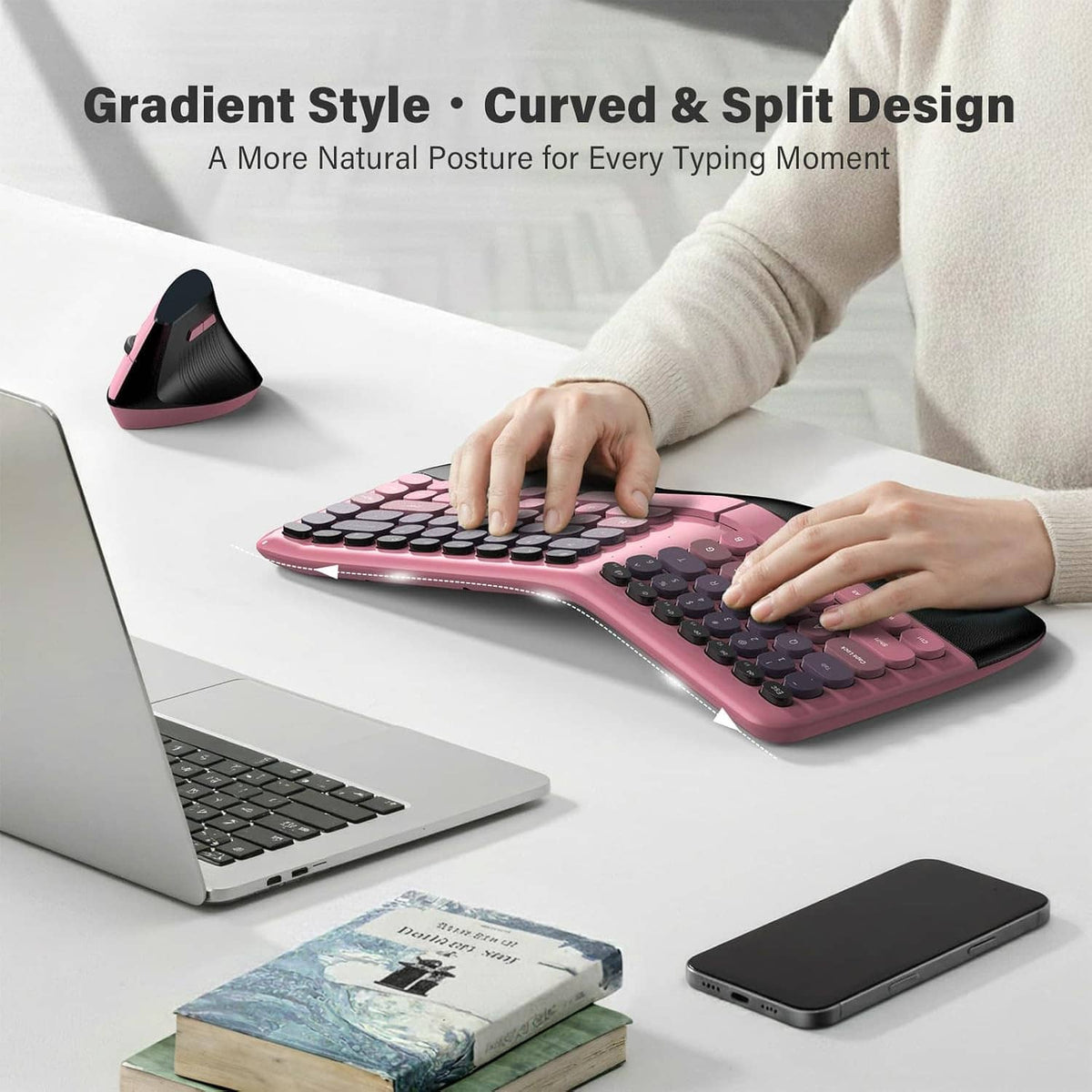 Pink split curved wireless keyboard with wrist rest, hands typing with mouse nearby