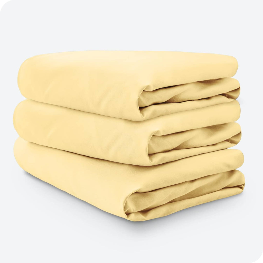 3-pack pale yellow microfiber fitted crib sheets stacked together