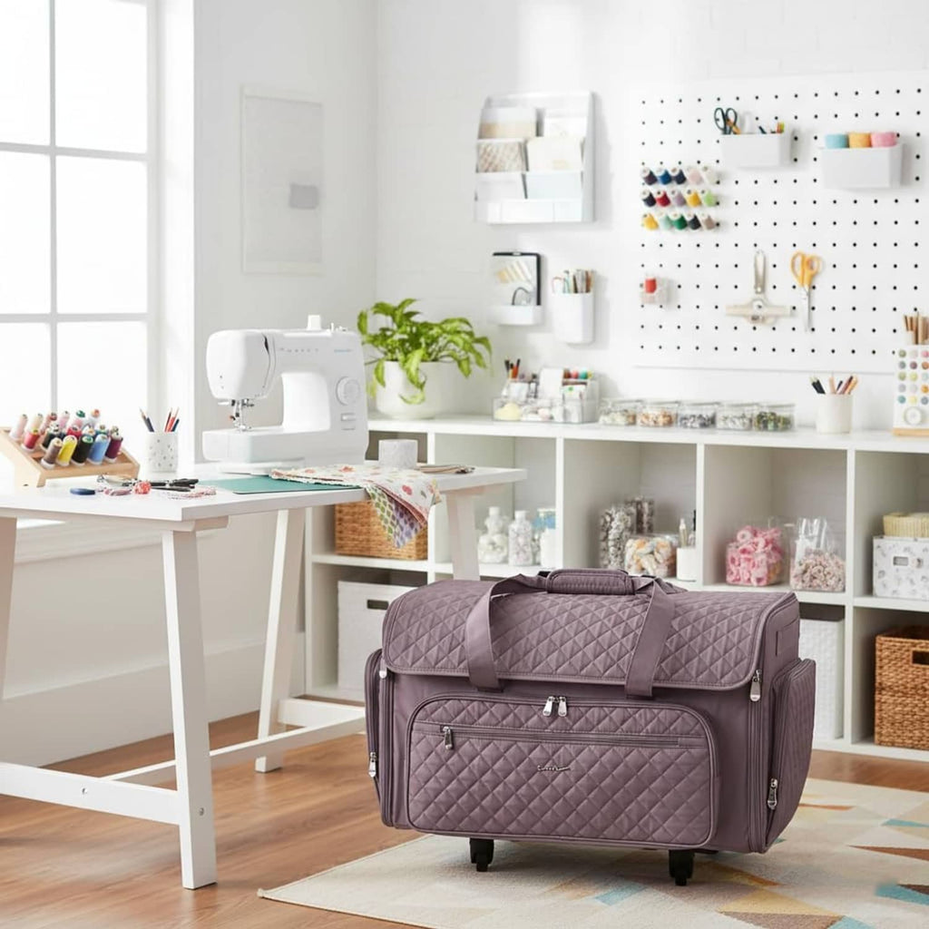Purple quilted rolling sewing machine case standing on 4 wheels in a craft room