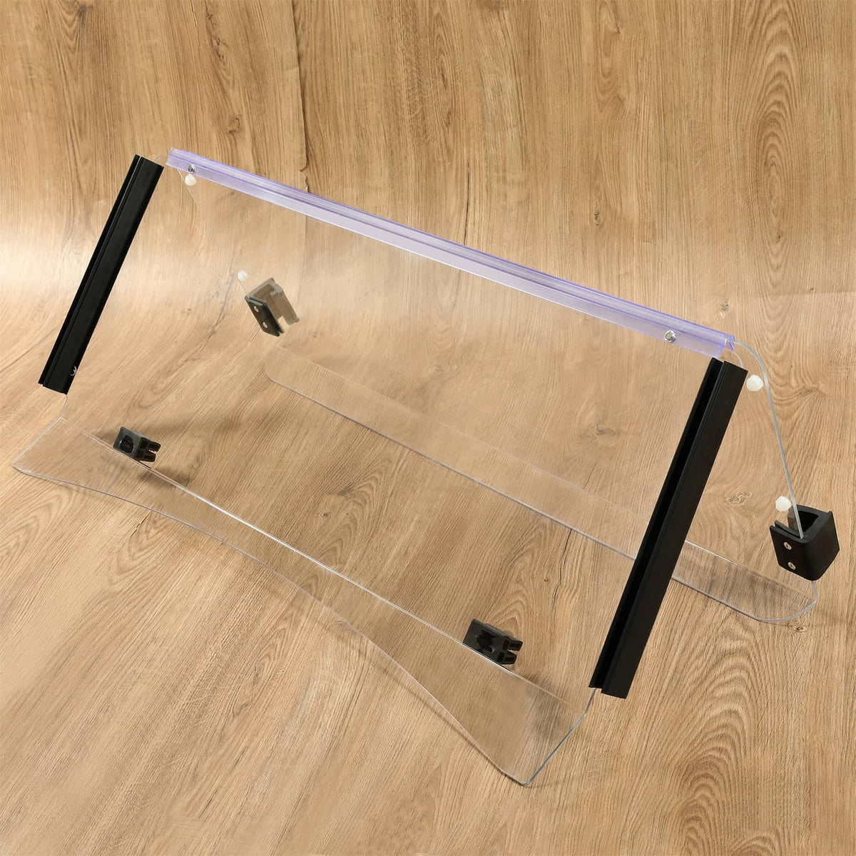 Clear folding windshield panel with black frame and mounting brackets