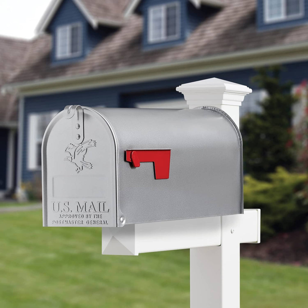 Silver spray-painted mailbox with red mail flag and white mounting bracket