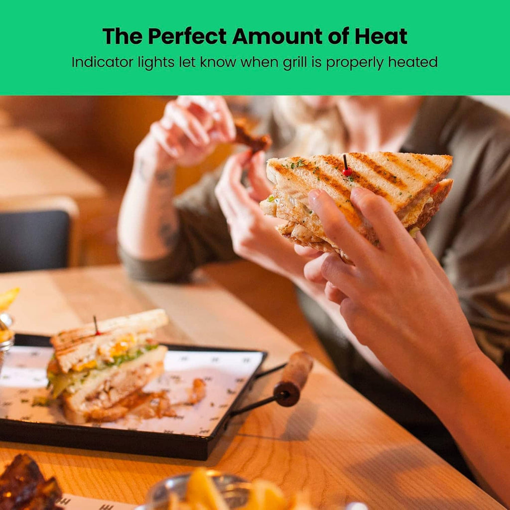 Panini press grill with power indicator lights and a lifted grilled sandwich