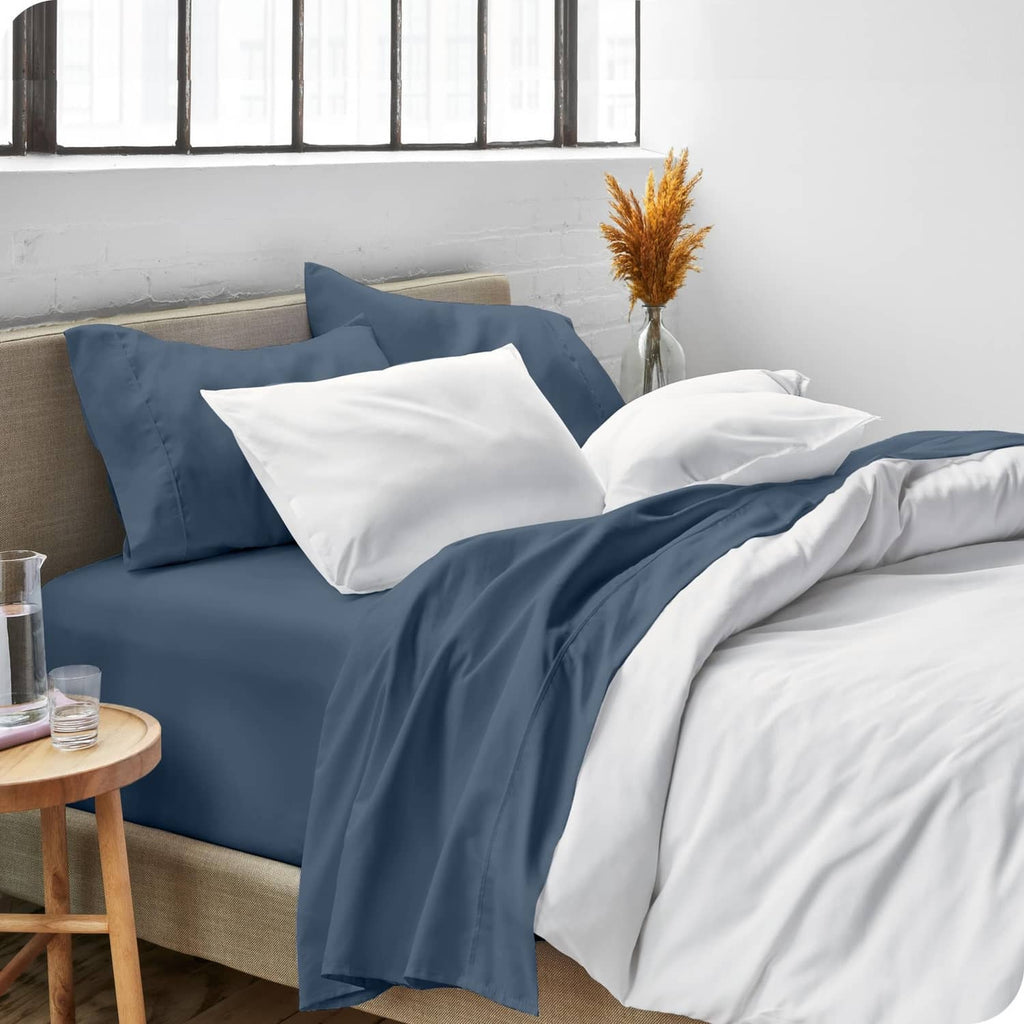 Blue twin sheet set with two pillowcases and a flat top sheet over a bed
