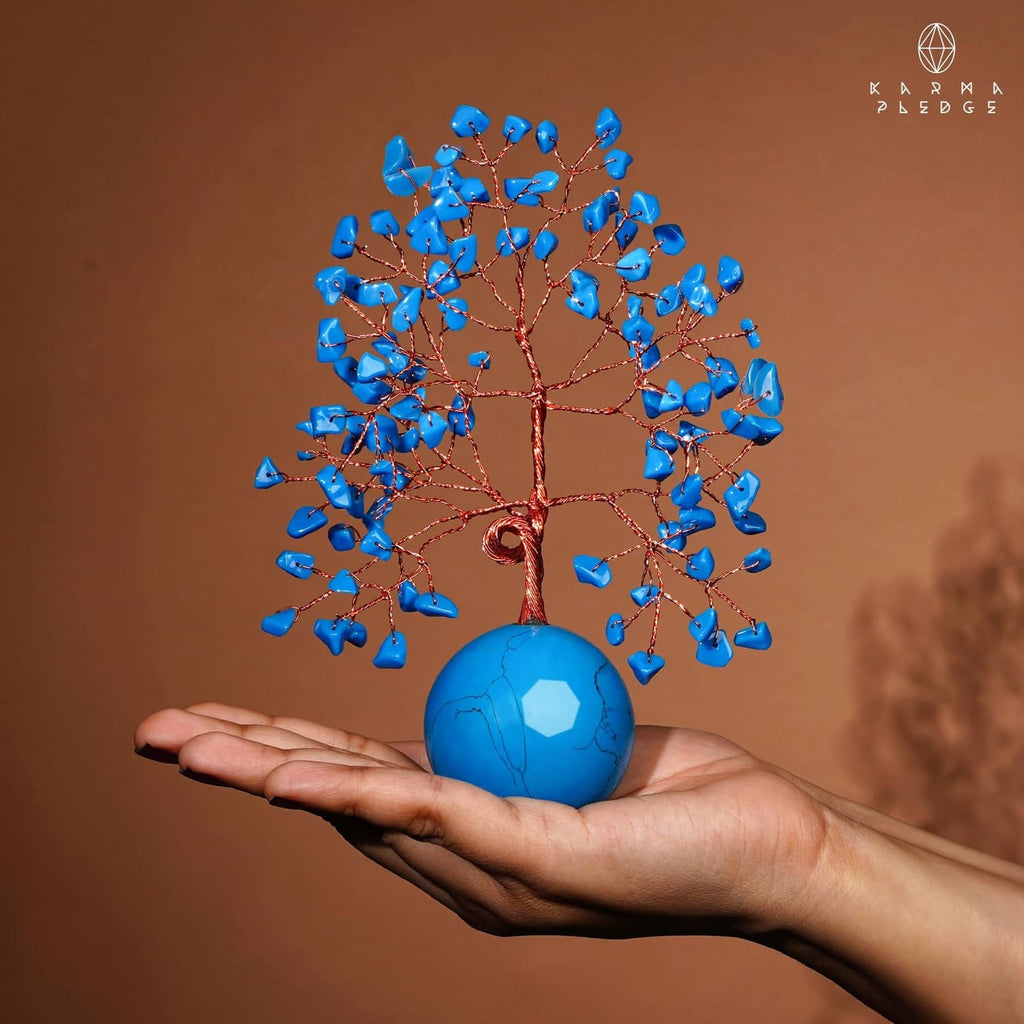 Turquoise ball base Tree of Life ornament held in hand, with blue crystal leaves