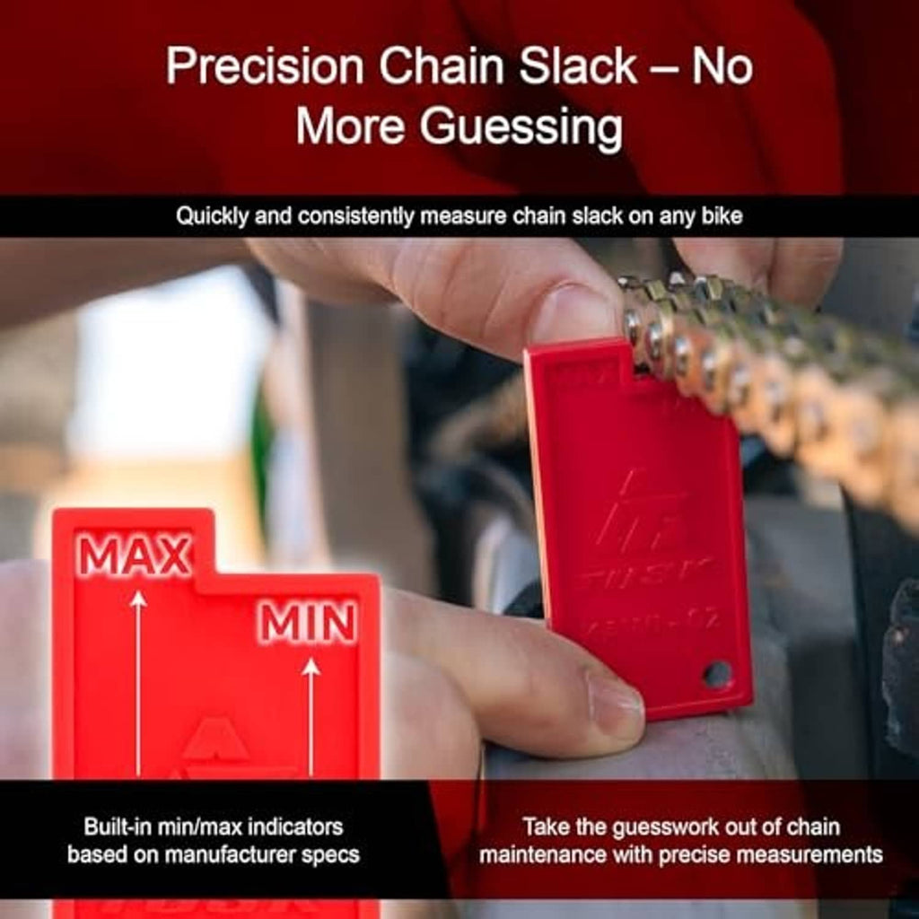 Red chain slack measuring tool positioned on a motorcycle chain near MAX/MIN