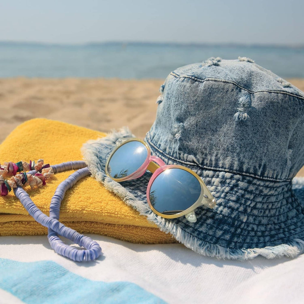 Textile in beach scene with denim bucket hat and sunglasses