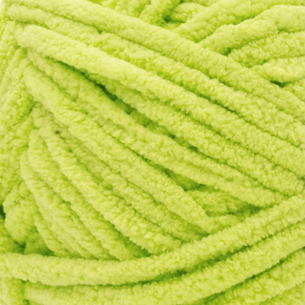Bright green chunky yarn texture, thick loops for knitting and crochet.