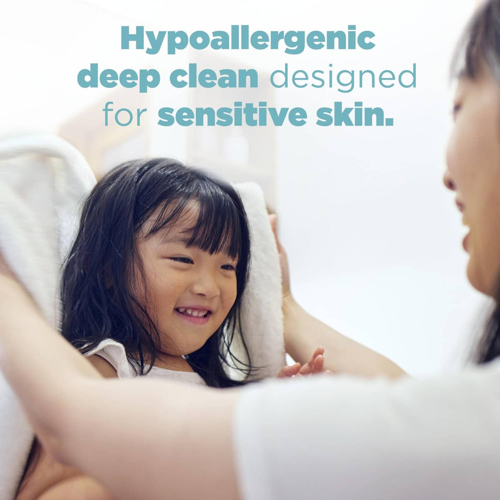 Child relaxing in bed with an adult, using Tide hypoallergenic detergent