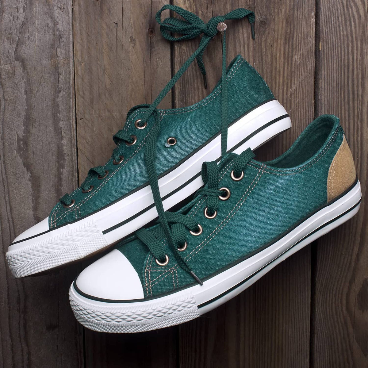 Teal canvas sneakers with lace-up eyelets and white rubber sole
