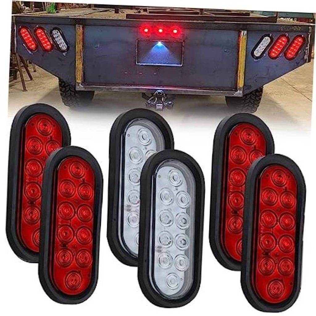 Oval LED trailer tail lights set with red lenses and one white oval lamp, black housings.