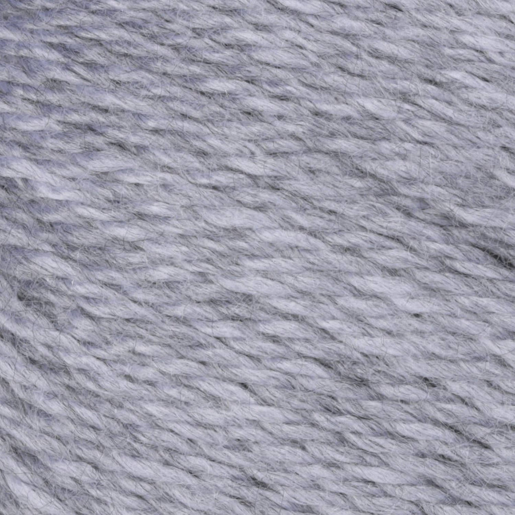 Light gray acrylic yarn close-up showing twisted strand texture