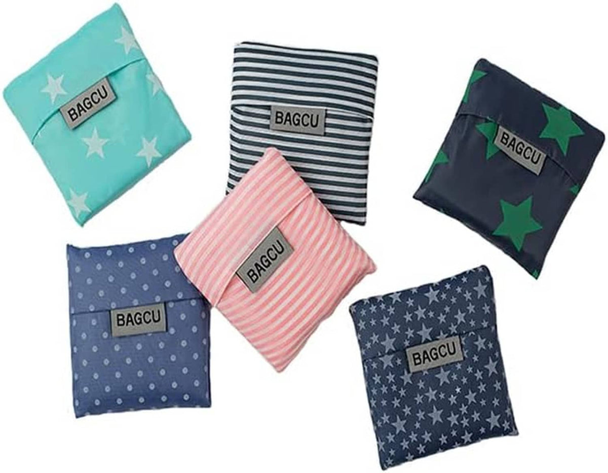 Foldable tote bag set with compact folded pouches featuring aqua stars, navy stripes, and star prints