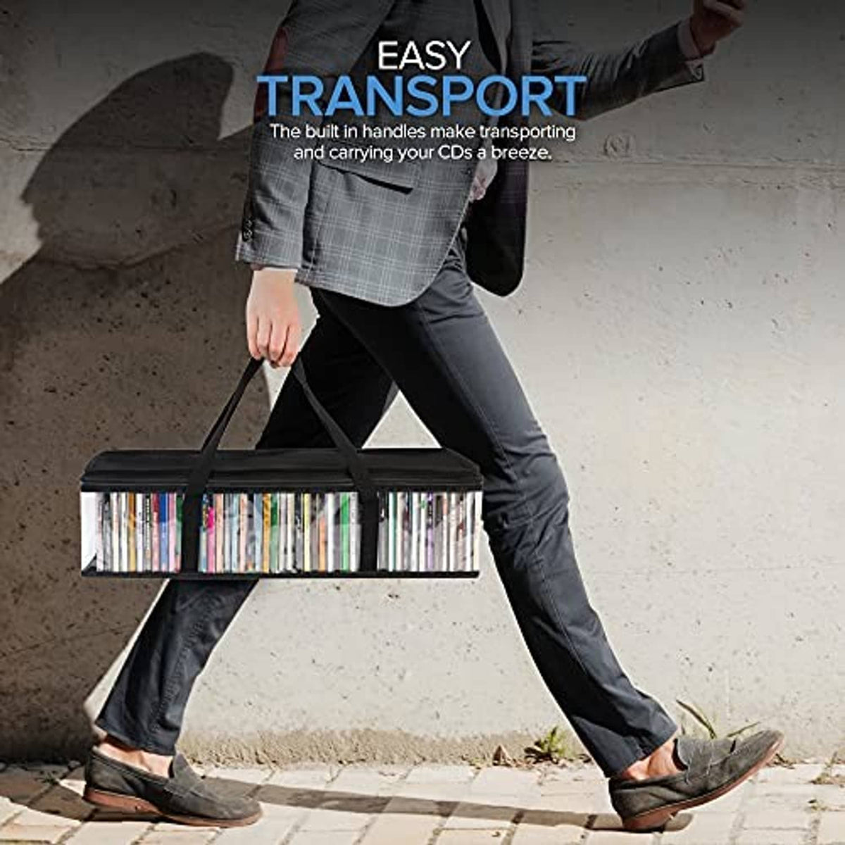 Clear PVC CD storage bag carried by black handles; long zip top with CD spines