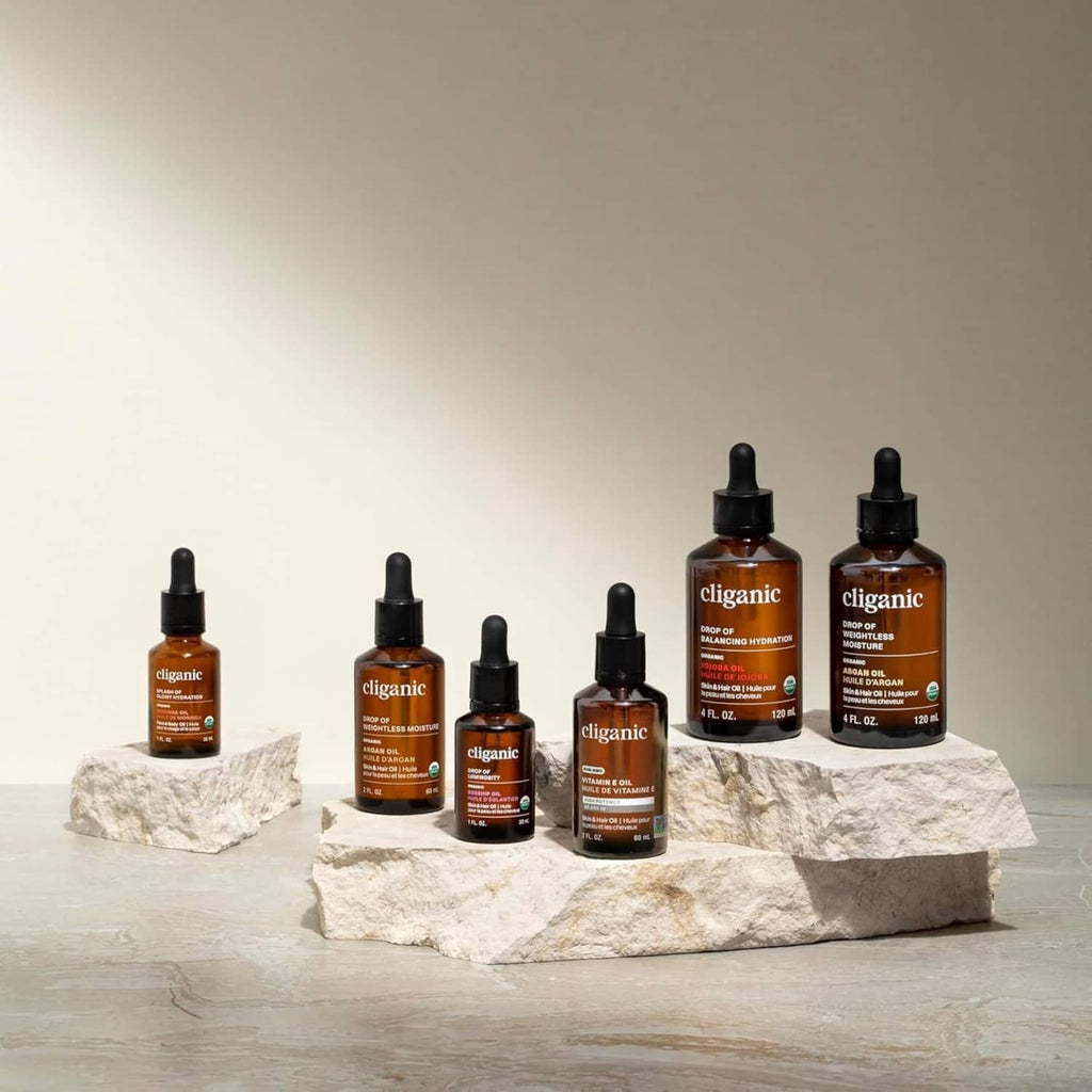 Cliganic Vitamin E oil bottles display, amber glass with black dropper tops