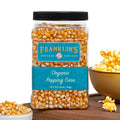 Organic popcorn kernels in clear jar with black lid, Franklin’s Gourmet label.