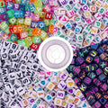 Tray of mixed letter cube beads in bright multicolor tones