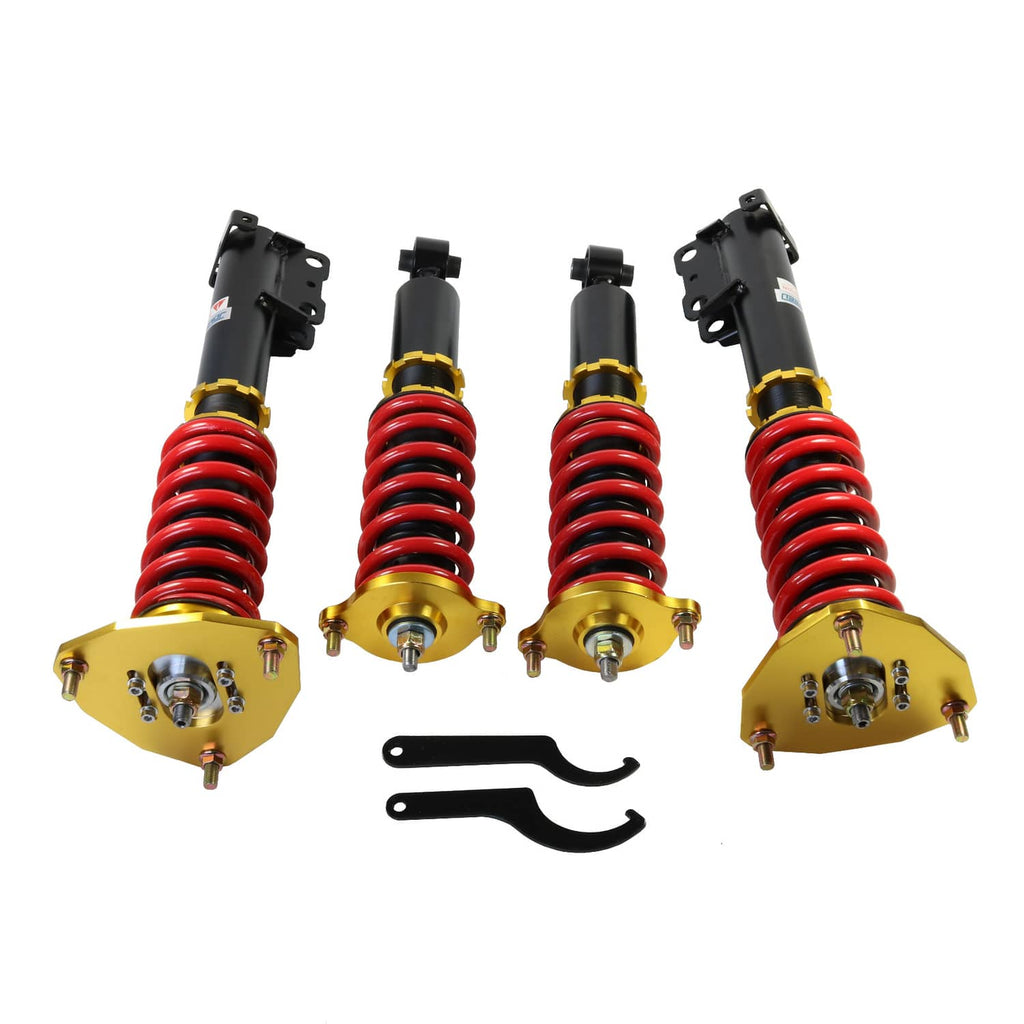 Four coilover suspension struts with red springs, gold upper plates, and black brackets