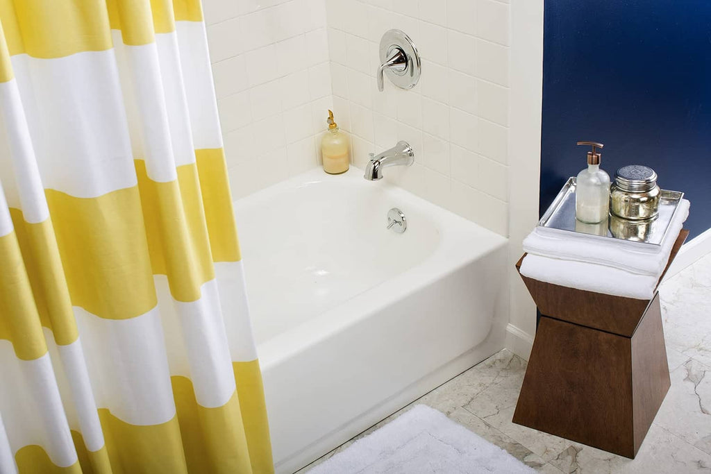 Gloss white tub and tile finish on bathroom bathtub with chrome faucet