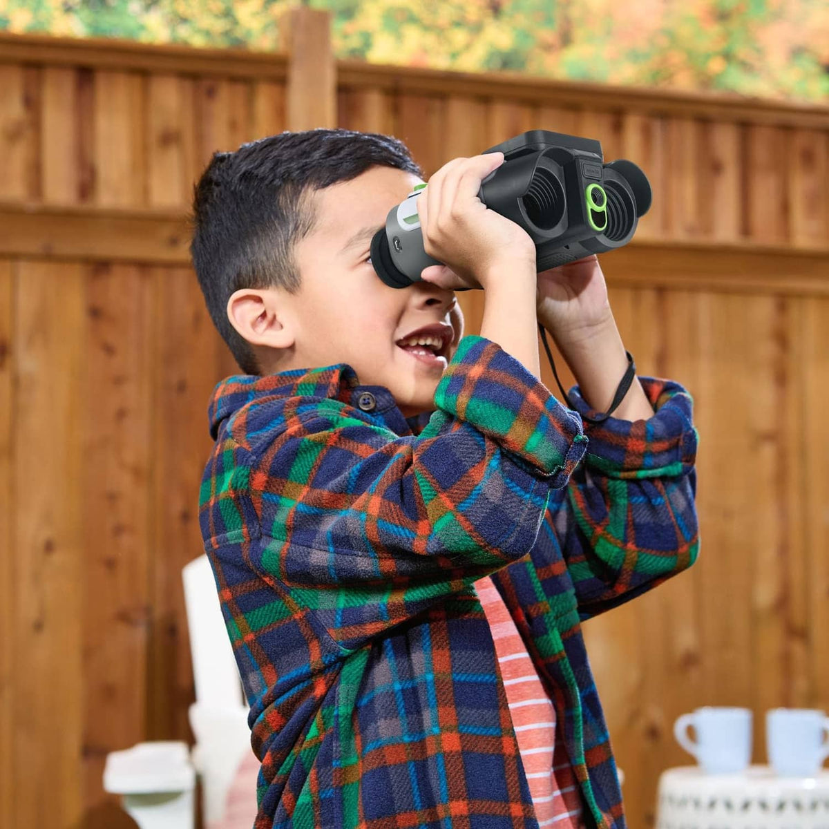 Child using white kids binoculars with built-in color screen
