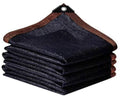 Folded dark mesh shade cloth tarp with brown binding edges and grommet corner tabs